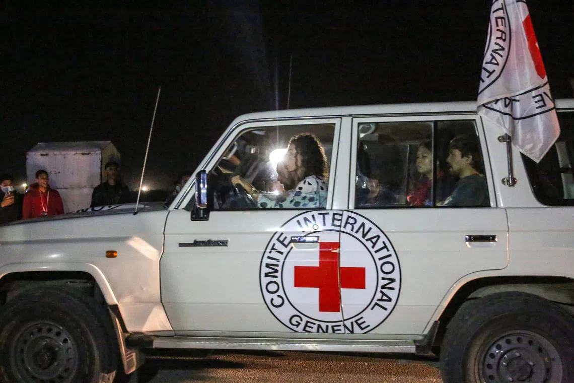 Vehicles with the International Committee of the Red Cross believed to be carrying hostages released by Hamas heads through the border crossing with Egypt in Rafah, in the southern Gaza Strip, Nov. 24, 2023. Some two dozen hostages, including Thais and Israelis kidnapped in the Hamas-led assault on Israel, were freed after the start of a four-day cease-fire, and dozens of trucks carrying aid, including fuel, entered Gaza. (Samar Abu Elouf/The New York Times)