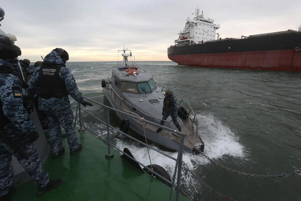 Ukrainian maritime inspectors prepare to board a cargo ship for checks, in the territorial waters of Ukraine.