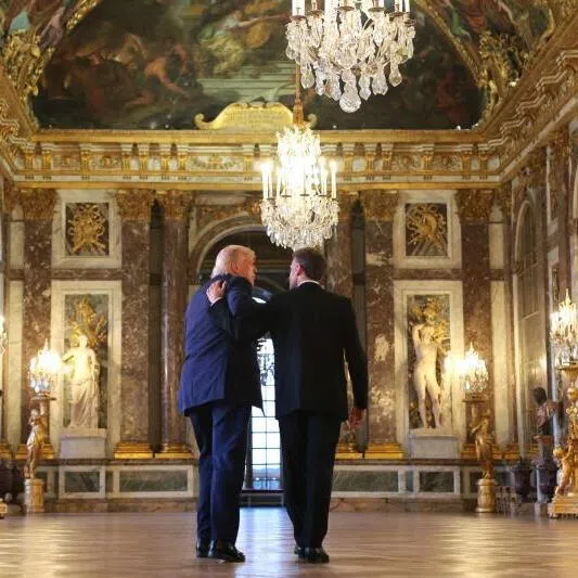 French President Emmanuel Macron (right) giving US President Donald Trump a tour of the Palace of Versailles before the dinner where Trump signed a hard copy of the US-Iran agreement.