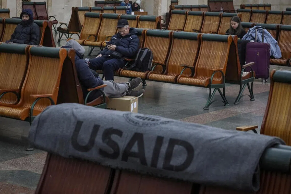 FILE PHOTO: Passengers rest in the waiting room as an one of the blankets donated by the United States Agency for International Development is seen, during a power outage after critical civil infrastructure was hit by a Russian missile attacks in Ukraine, as Russia's invasion of Ukraine continues, at central railway station in Kyiv, Ukraine November 25, 2022. REUTERS/Gleb Garanich/File Photo