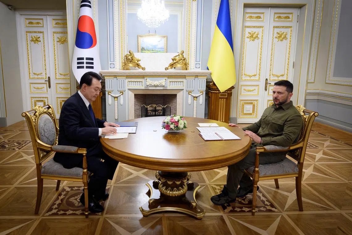 Ukraine's President Volodymyr Zelenskiy and South Korean President Yoon Suk Yeol attend a meeting, amid Russia's attack on Ukraine, in Kyiv, Ukraine July 15, 2023. Ukrainian Presidential Press Service/Handout via REUTERS/File Photo