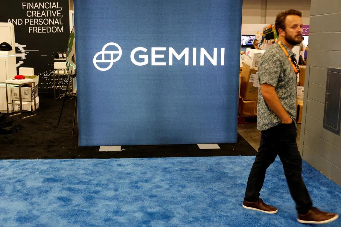 FILE PHOTO: A man walks past the logo of Gemini Trust, a digital currency exchange and custodian, during the Bitcoin Conference 2022 in Miami Beach, Florida, U.S. April 6, 2022. REUTERS/Marco Bello/File Photo