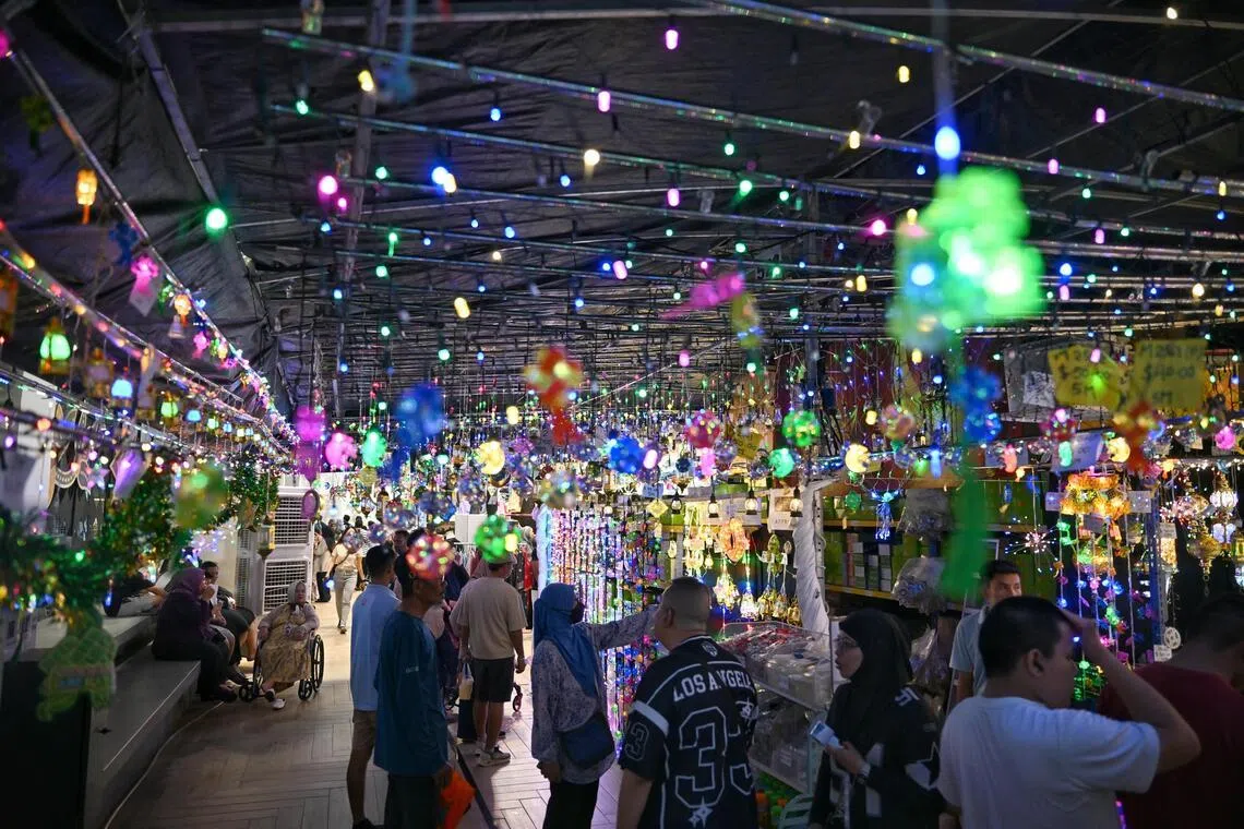 The rain-sodden streets of Geylang Serai glistened as the annual Hari Raya light-up kicked off on Feb 14.