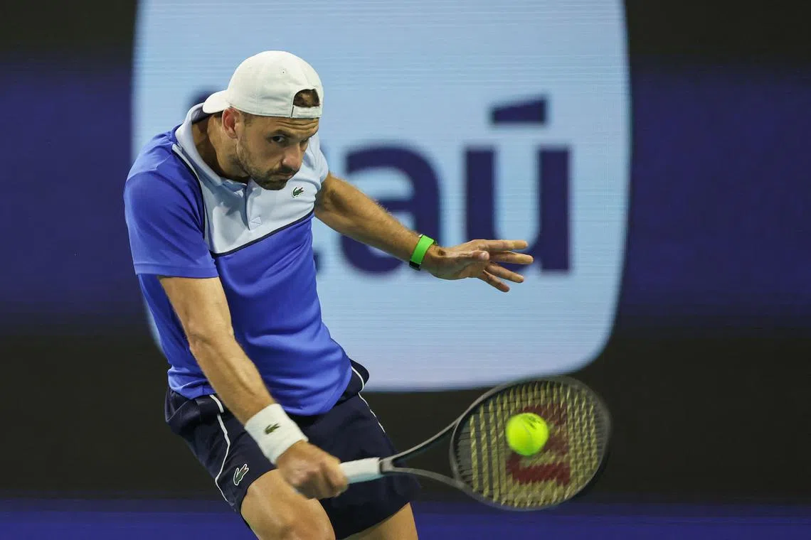 Grigor Dimitrov of Bulgaria hits a shot against Alexander Zverev of Germany during the Men's semifinal at Hard Rock Stadium on March 29.