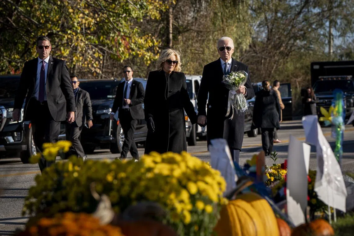 US President Joe Biden and first lady Jill Biden lay flowers at a makeshift memorial outside of Schemengees Bar & Grill, one of the sites of a mass shooting, in Lewiston, Maine, on Nov 3.