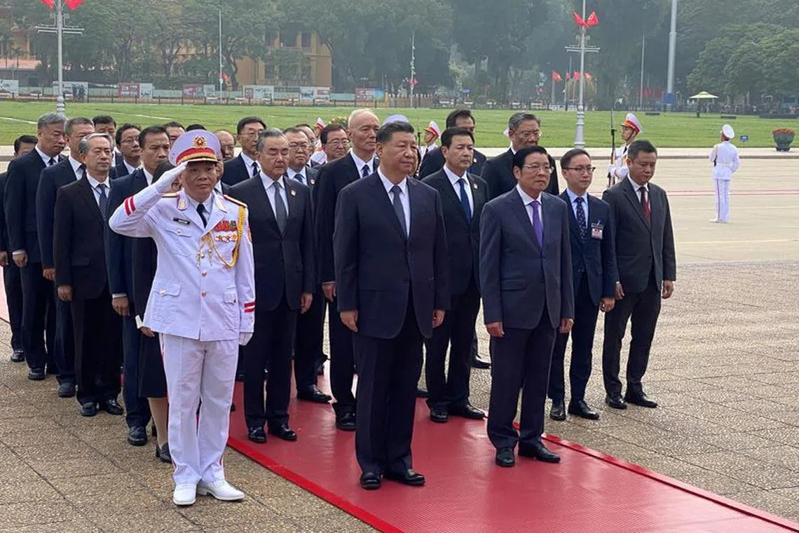FILE PHOTO: Chinese President Xi Jinping attends a  lay wreath ceremony at the Ho Chi Minh mausoleum during a two day state visit to Hanoi, Vietnam December 13, 2023. REUTERS/Thinh Nguyen/File Photo