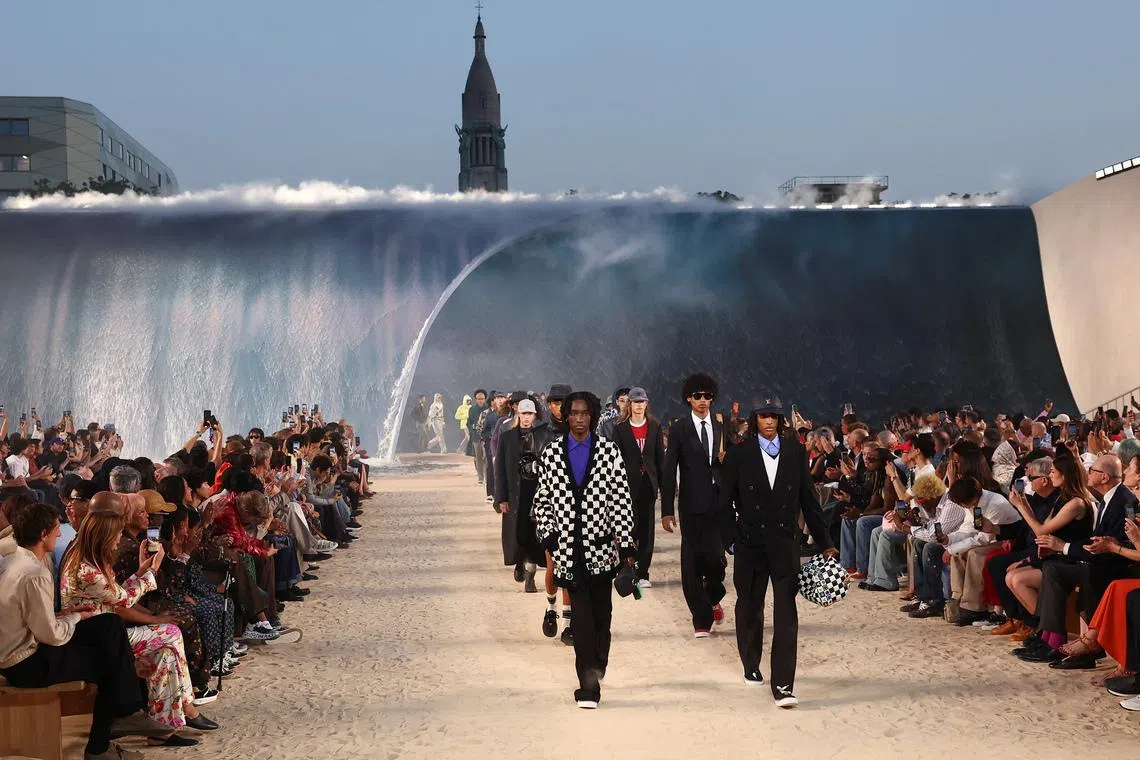 Models present creations by designer and musician Pharrell Williams as part of his Menswear Spring-Summer 2027 collection show for fashion house Louis Vuitton during Men's Fashion Week in Paris, France, June 23, 2026. REUTERS/Gonzalo Fuentes