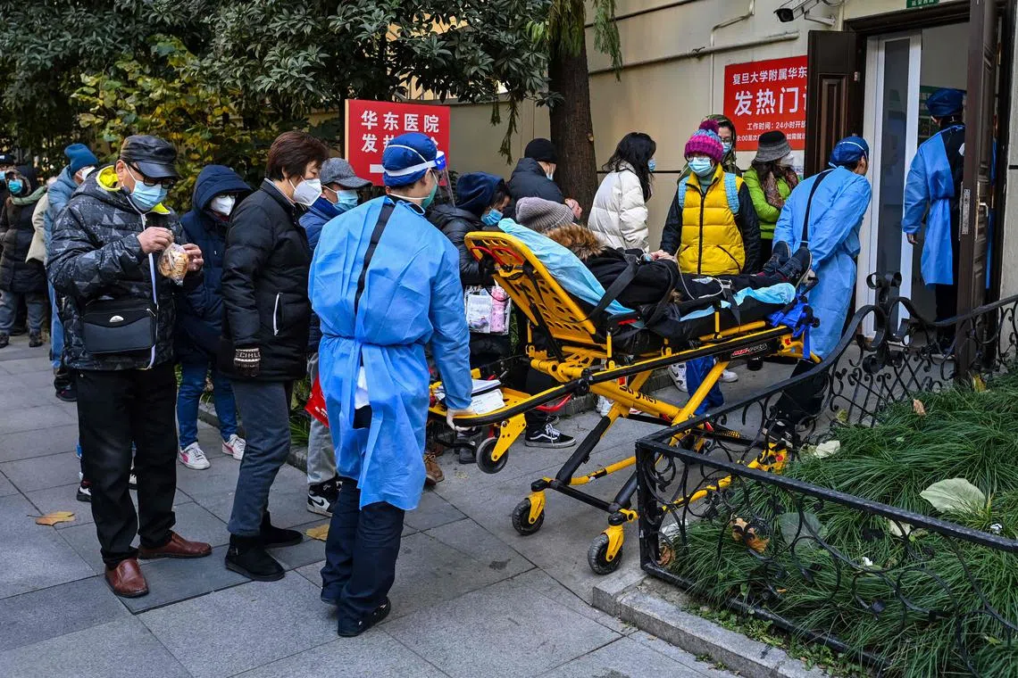 Staff transport a patient to a fever clinic at Huadong hospital in Shanghai on Dec 19, 2022.