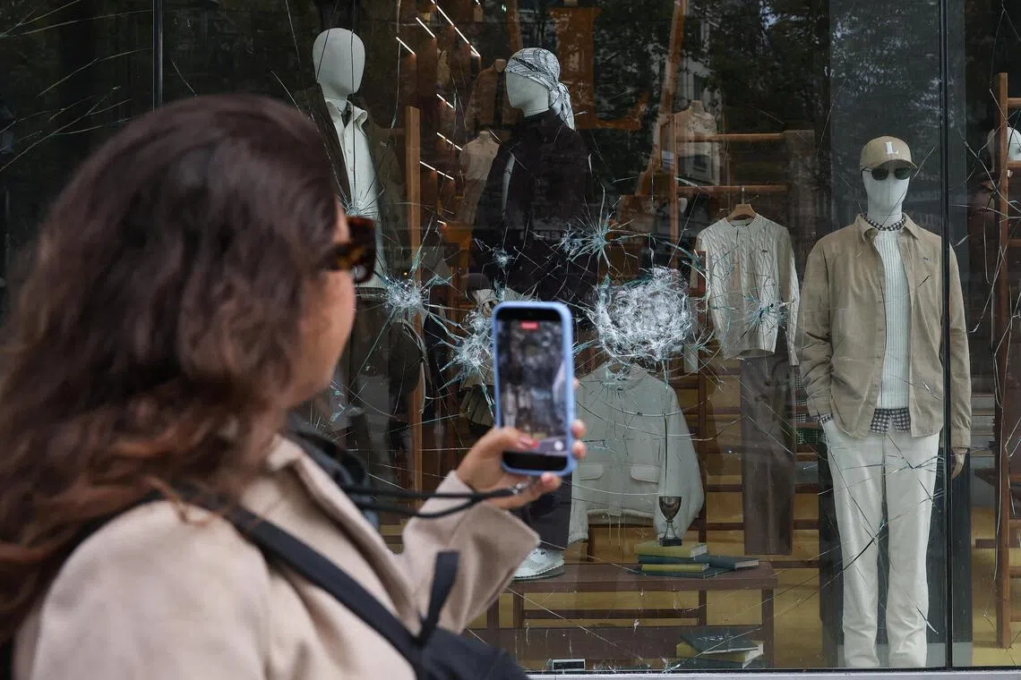 Damaged glass of the Lacoste store on Champs-Elysees avenue, vandalised during clashes on Oct 17 and 18.