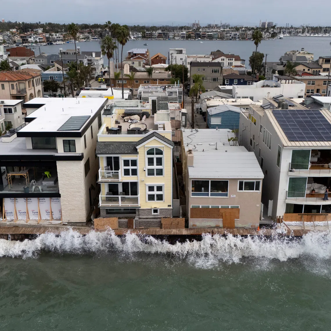A drone view shows waves crashing into a boardwalk in Long Beach, California, US, September 16, 2026. REUTERS/Daniel Cole