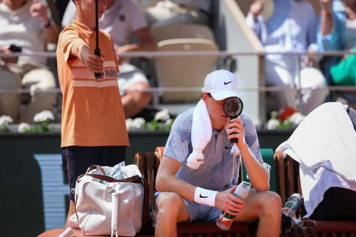 Italy's Jannik Sinner trying to cool down during a break of play in his men's singles match against Argentina's Juan Manuel Cerundolo at the French Open on May 28. 