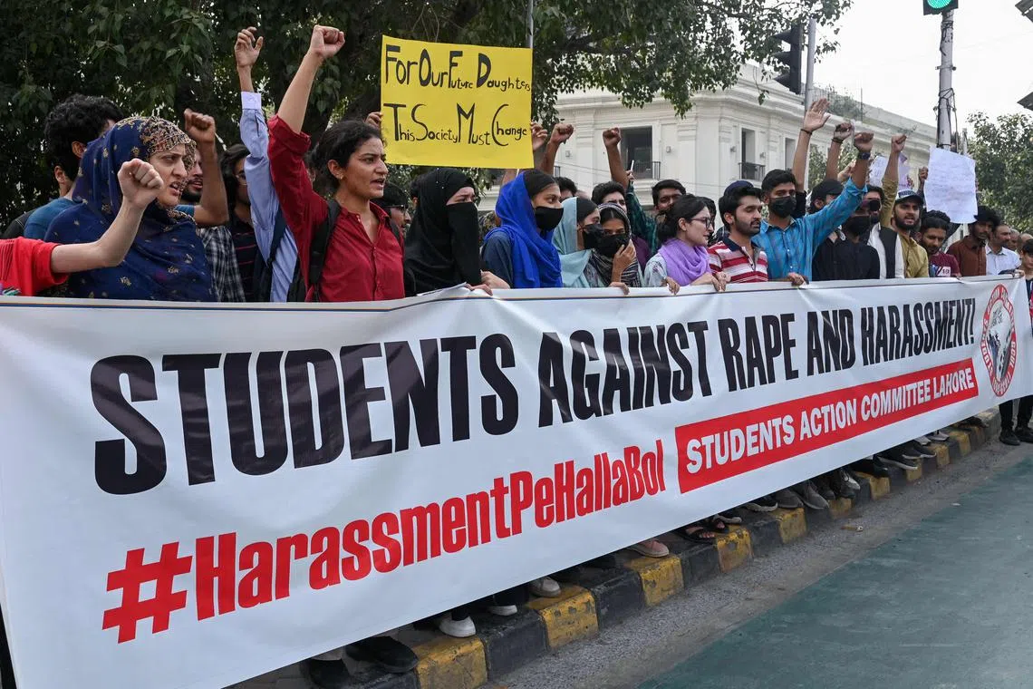 Students holding a poster shout slogans during a protest march to condemn the alleged rape of a female student, in Lahore, on Oct 21, 2024.