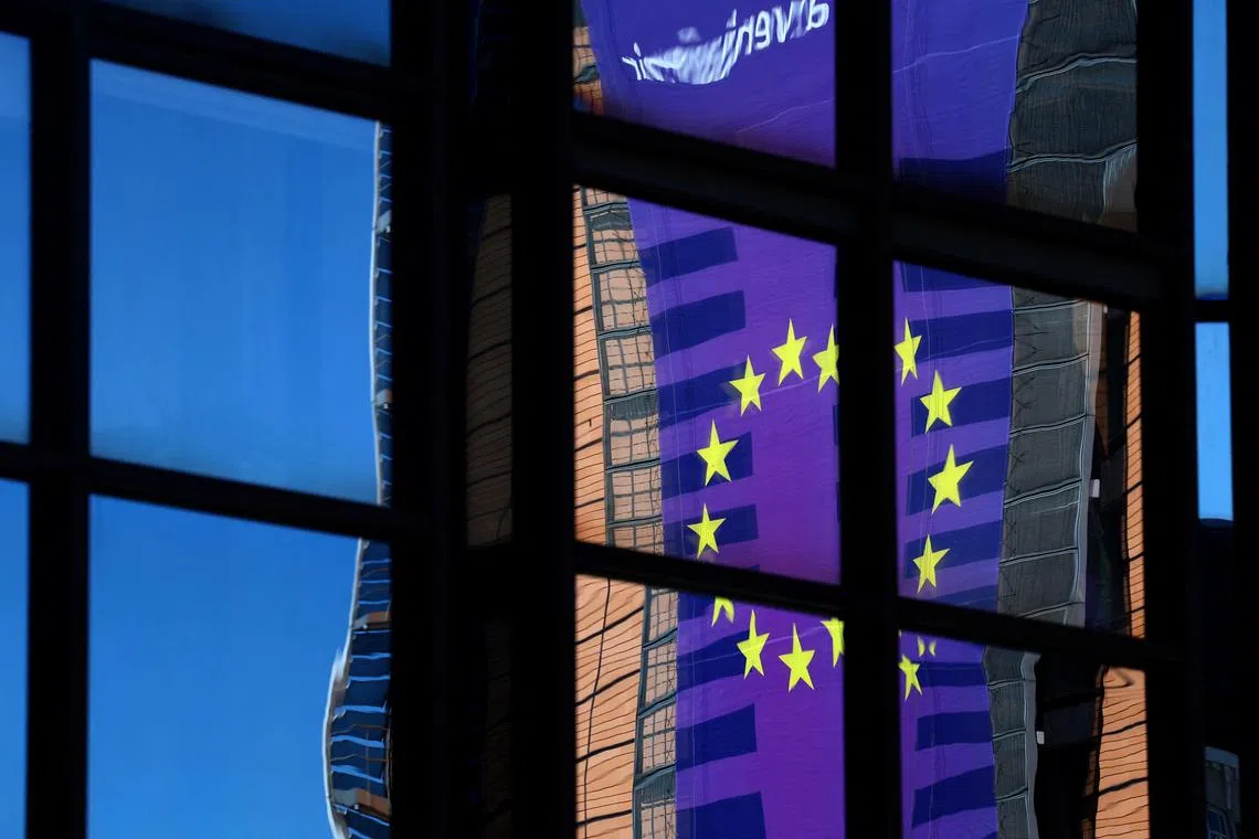 FILE PHOTO: A banner depicting an European Union flag is reflected in a window outside the EU Council headquarters in Brussels, Belgium March 18, 2025. REUTERS/Yves Herman/ File Photo