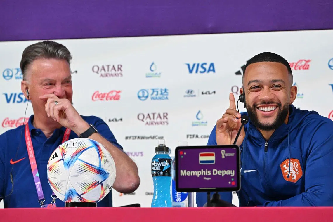 Netherlands coach Louis van Gaal and striker Memphis Depay sharing a laugh during a press conference on Dec 8, 2022.