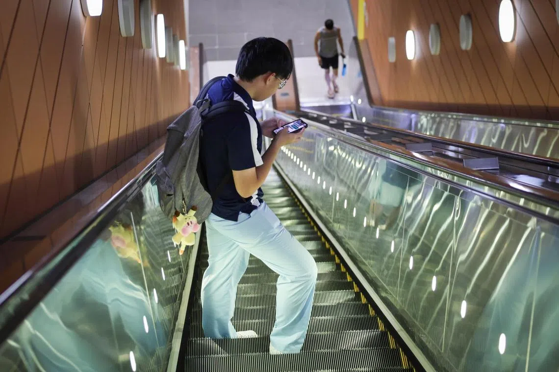ST20240301_202414828979: Gin Tay/ pixgeneric/

Generic photo of a teenager using mobile phone while travelling on an escalator at Steven MRT station on Feb 29, 2024. 

Can use for stories on youth, mobile phone, social media addiction, mental health, app, gaming, telcos, 4G , 5G,