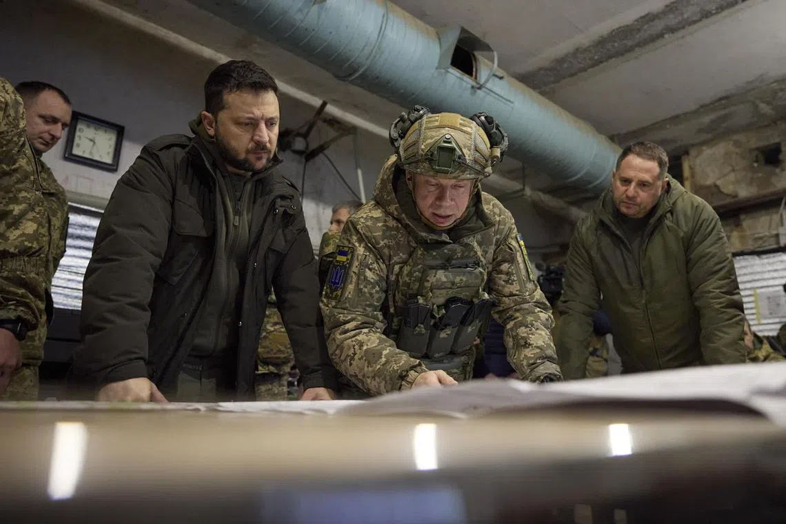 Ukrainian President Volodymyr Zelensky (left) takes part in a meeting with commanders near Kupyansk.