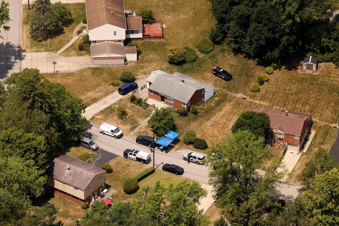 An aerial view shows law enforcement members at the home of 20-year-old Thomas Matthew Crooks. He was one of several students who appeared in the background of the 2022 ad.