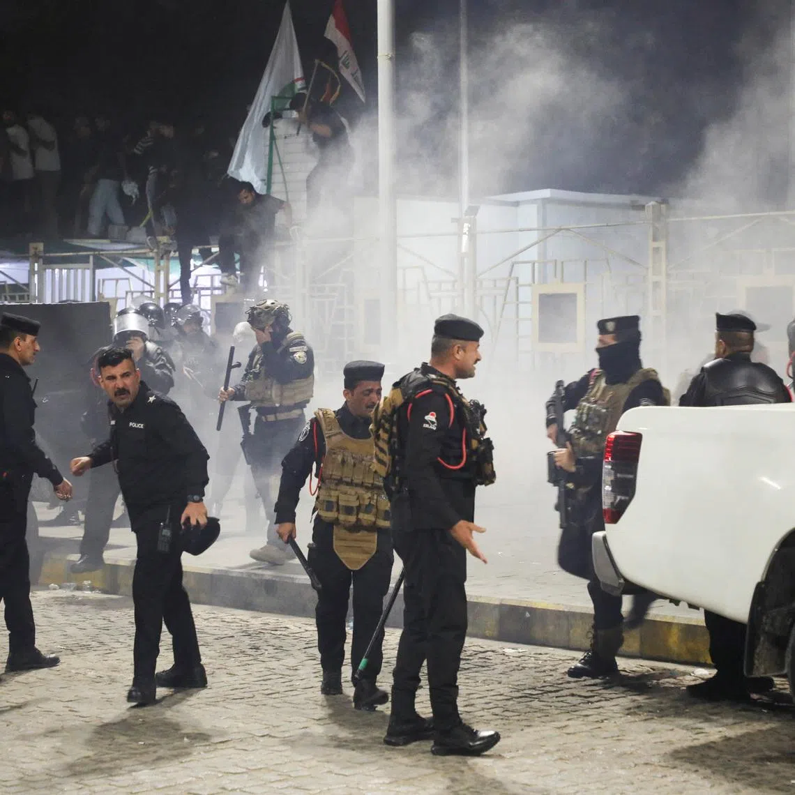 Iraqi security forces gather outside the Kuwaiti consulate during a protest following rockets fired from the direction of Kuwait that hit a house in Khor al-Zubair, Basra, Iraq, April 7, 2026. REUTERS/Mohammed Aty