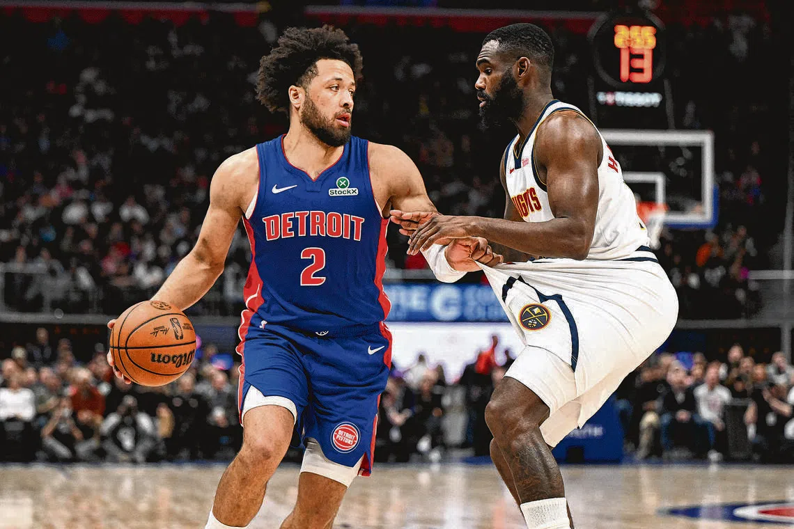 Detroit Pistons guard Cade Cunningham tugs on the shorts of Denver Nuggets guard Tim Hardaway Jr. before trying to drive past him in the second quarter at Little Caesars Arena.