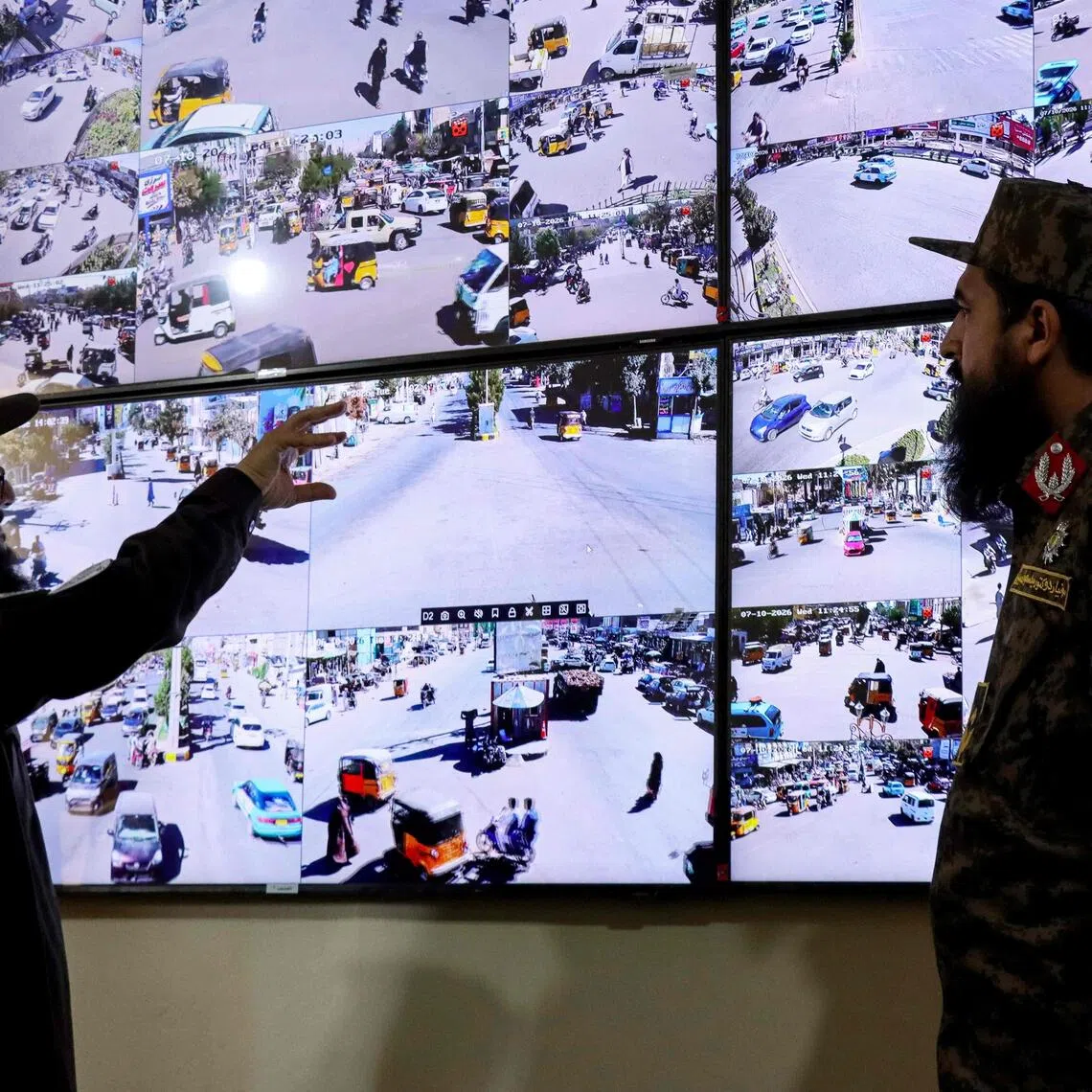 Taliban security personnel watch CCTV surveillance feeds of the city from the control room at the police headquarters in Herat on Oct 7.
