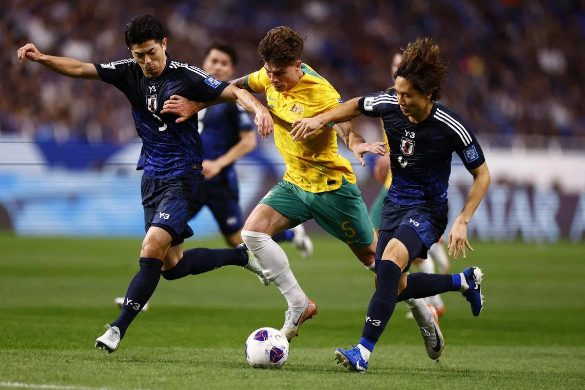 Japan's Shogo Taniguchi and Ko Itakura during a World Cup qualifier against Australia.