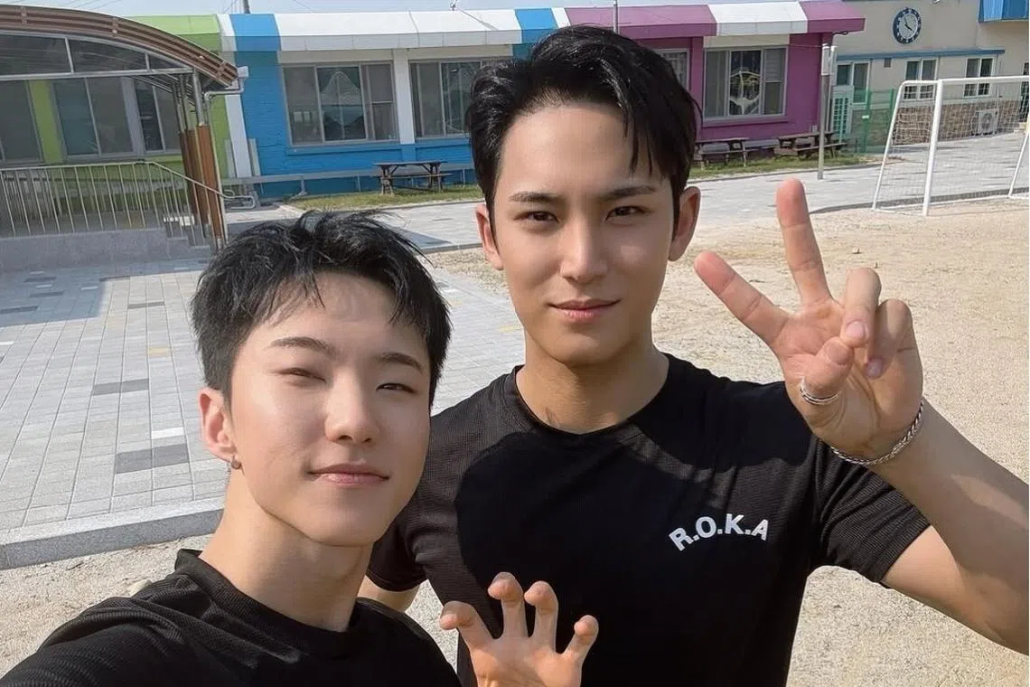 Seventeen’s Hoshi (left) and Mingyu wear plain black T-shirts stamped with R.O.K.A., short for Republic of Korea Army, on SBS’s variety show Whenever Possible. 