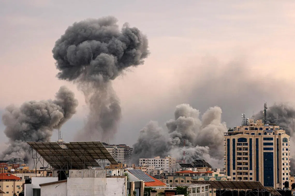 A plume of smoke rising over Gaza City during an Israeli airstrike on Oct 9.