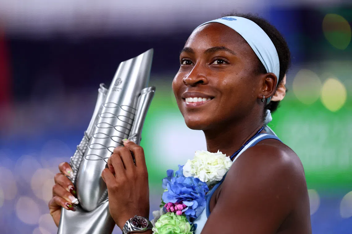Tennis - WTA 1000 - Wuhan Open - Optics Valley International Tennis Center, Wuhan, China - October 12, 2025 Coco Gauff of the U.S. celebrates with the trophy after winning the final against Jessica Pegula of the U.S. REUTERS/Tingshu Wang