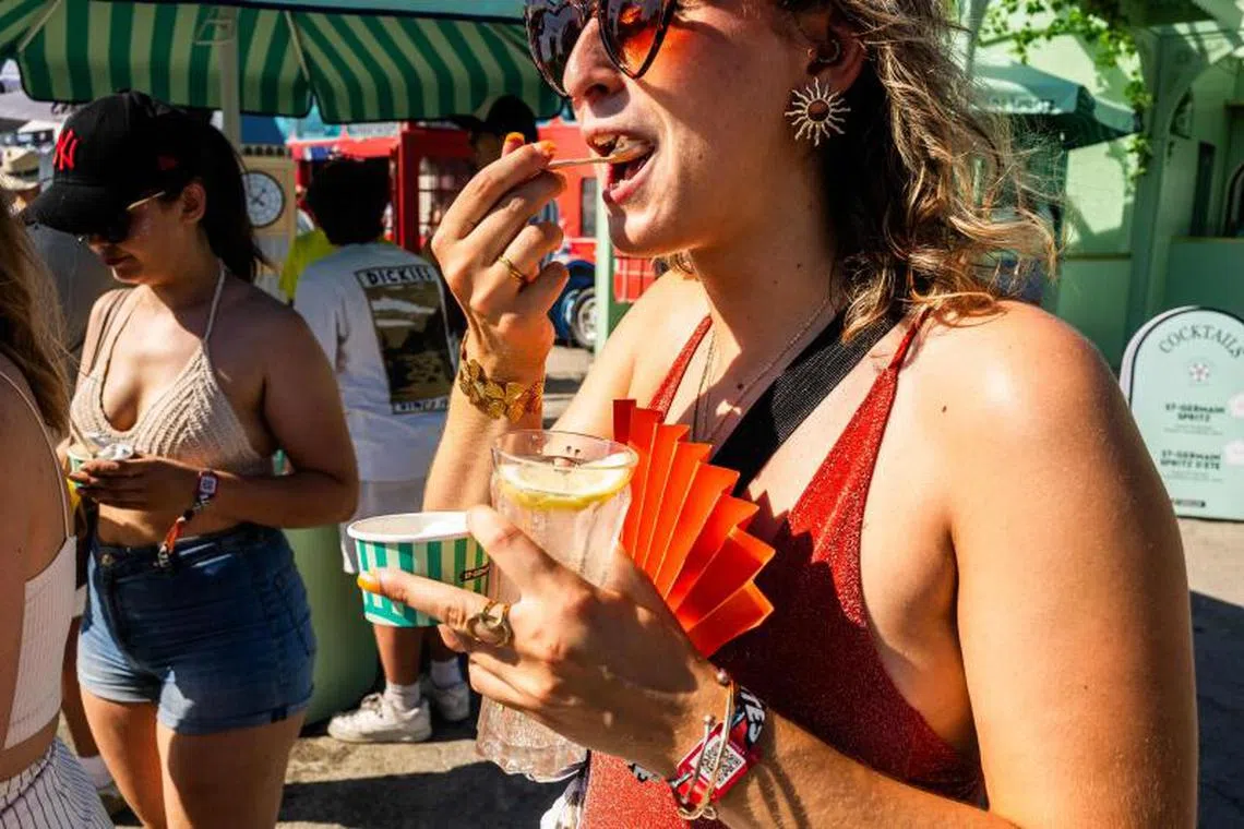 People eating an ice cream at a music festival amidst a heatwave in southern France, on June 29.