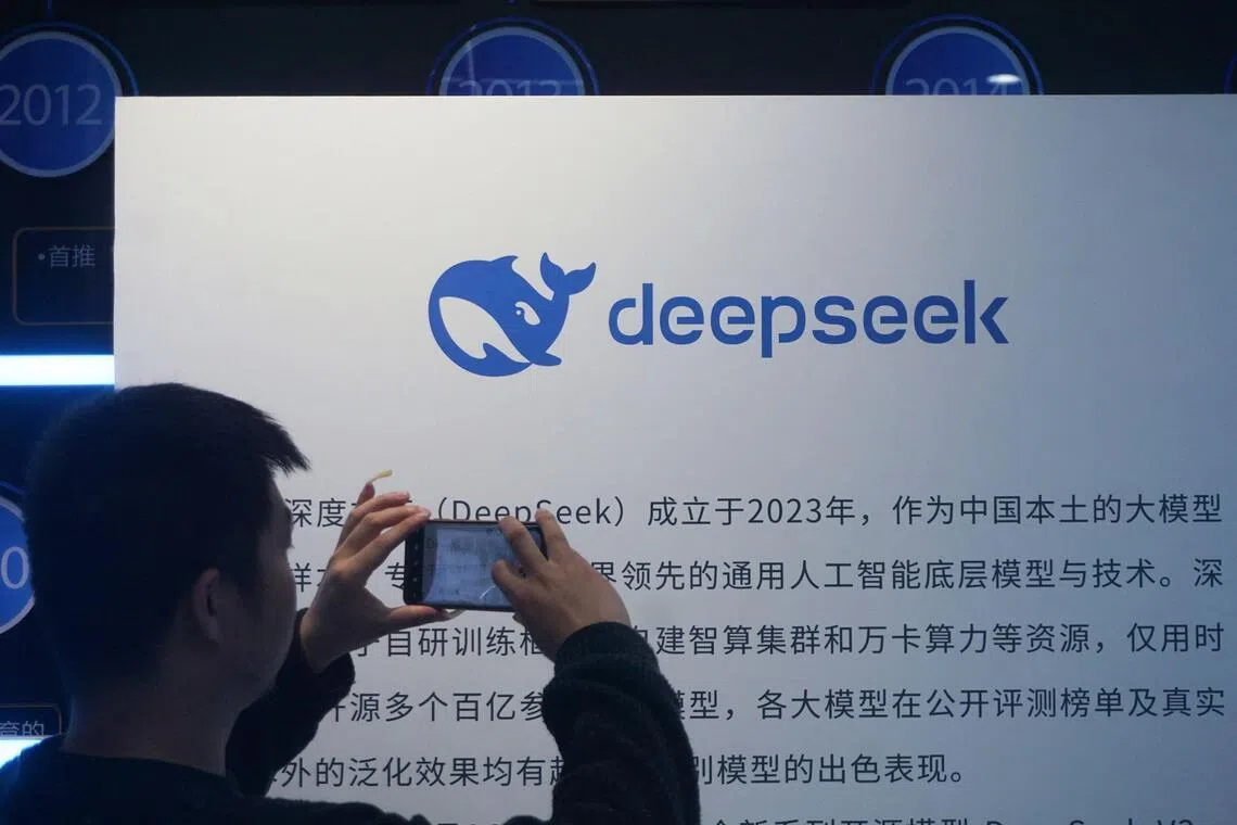 A man takes photos of a DeepSeek display at a shopping mall in Hangzhou, in China’s eastern Zhejiang province on April 23, 2026. Chinese startup DeepSeek released a new artificial intelligence model with "drastically reduced" costs on April 24, more than a year after it stunned the world with a low-cost reasoning model that matched the capabilities of US rivals. (Photo by CN-STR / AFP) / China OUT