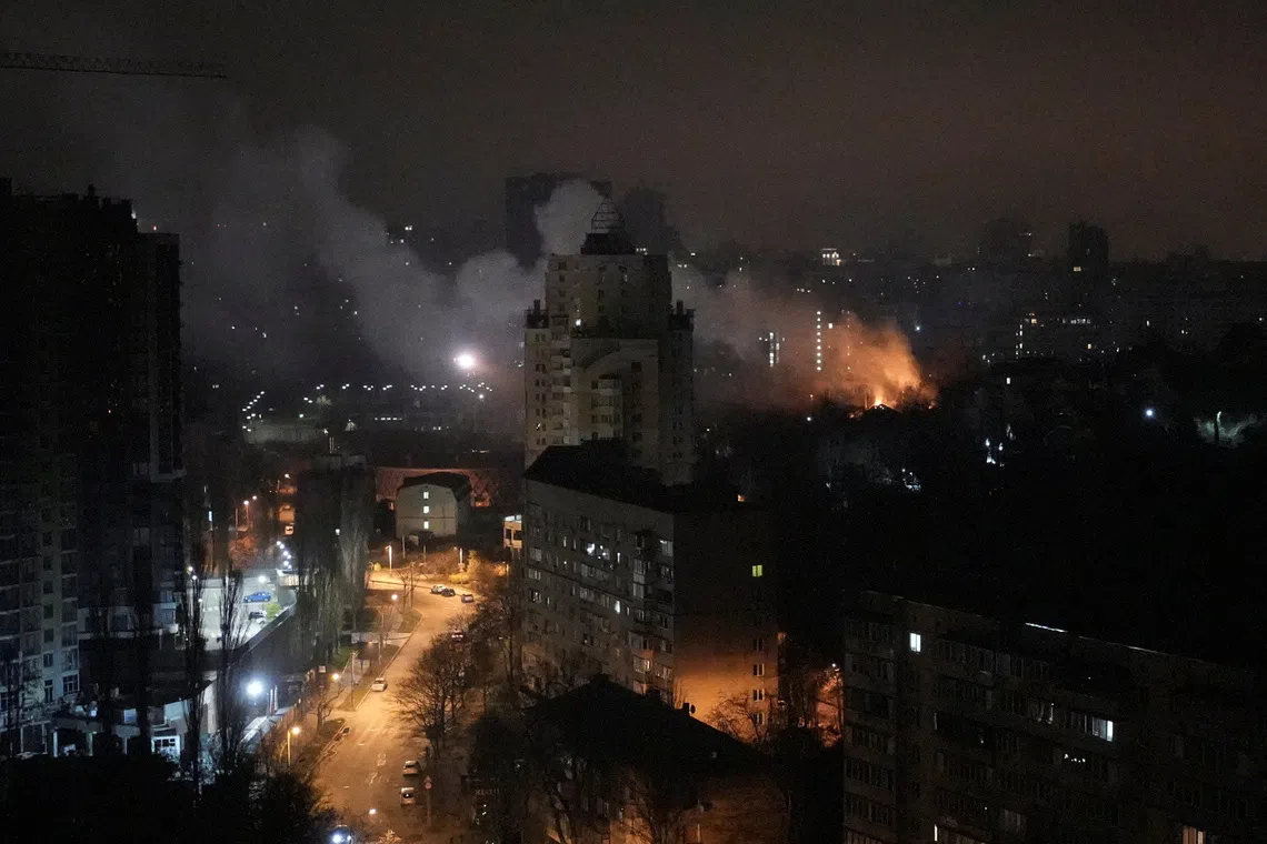 Residential buildings burning after Russian missile and drone strikes in Kyiv on Nov 29.