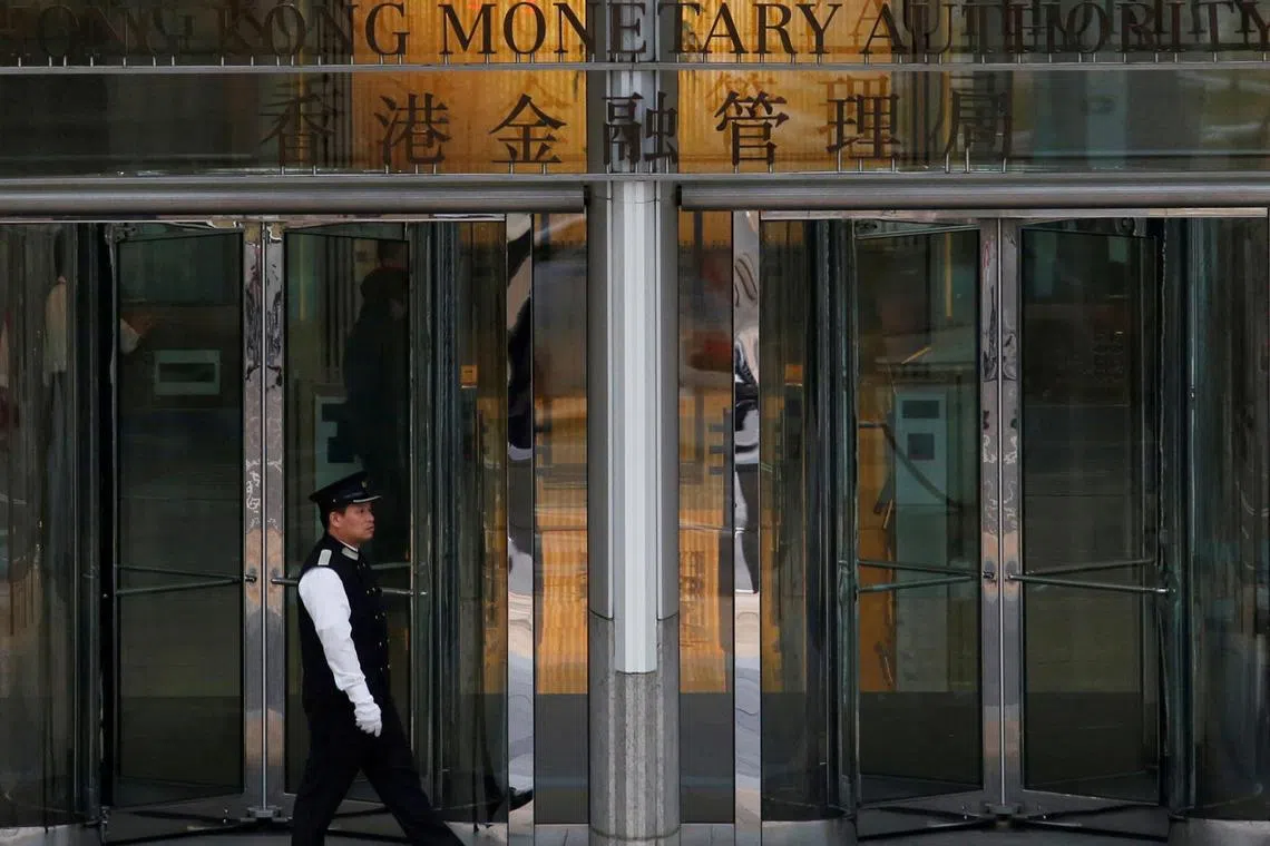 An attendant walks outside the entrance to Hong Kong Monetary Authority in Hong Kong, China November 10, 2015. Picture taken November 10, 2015. REUTERS/Bobby Yip/File Photo