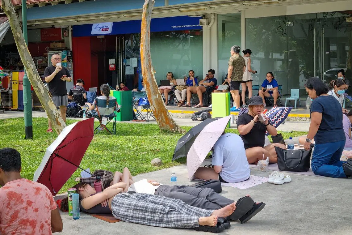 Fans of Taylor Swift queueing for physical tickets at the Toa Payoh North SingPost outlet, on July 7, 2023.