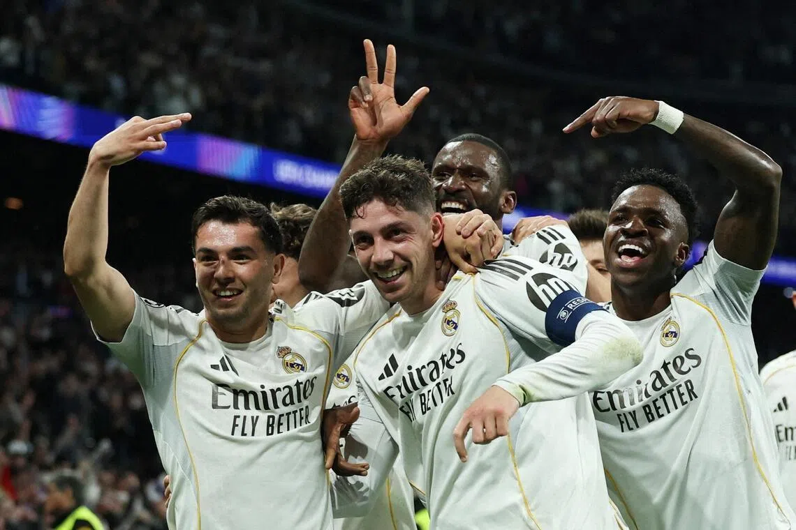 Real Madrid's Federico Valverde celebrates scoring their third goal with teammates.