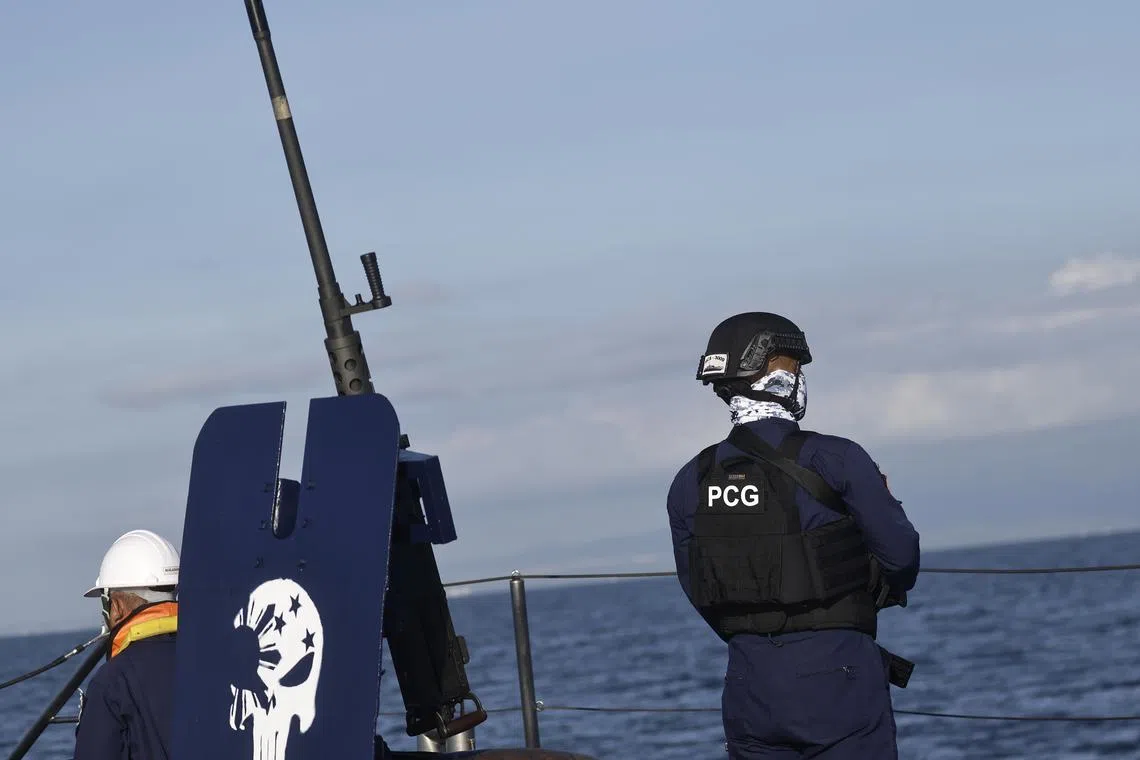 Philippine Coast Guard personnel man the deck of a patrol vessel along the Manila Bay on April 8.
