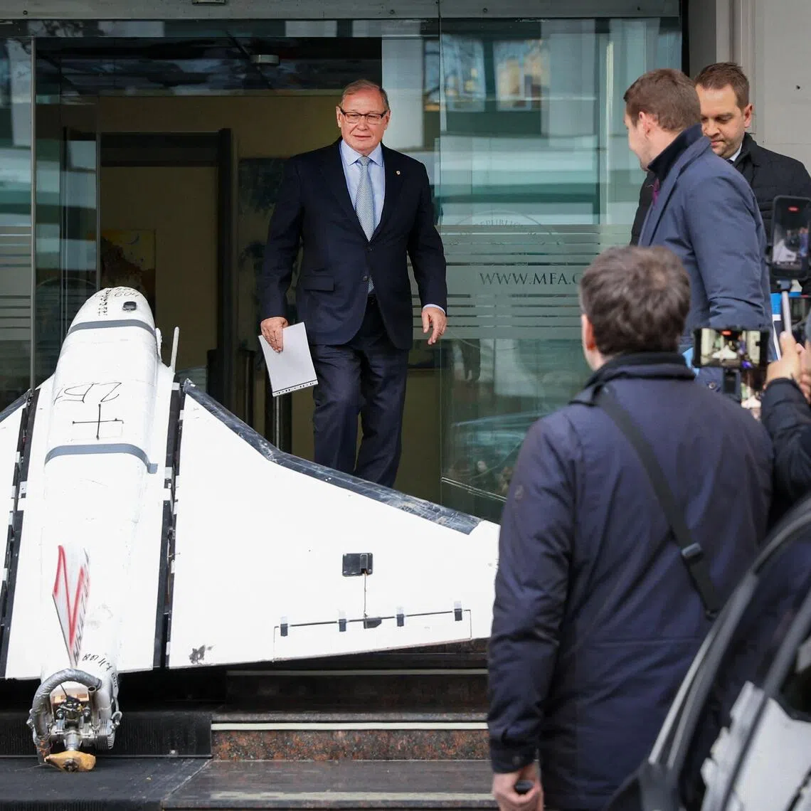 Russian ambassador to Chisinau Oleg Ozerov passing a Russian-made Gerbera drone on Nov 26 after it was placed at the entrance to the Ministry of Foreign Affairs.