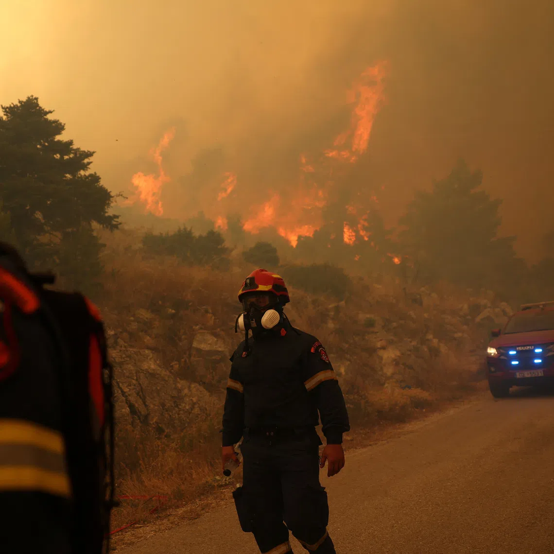 Firefighters work as a wildfire burns on Mount Kithairon, Greece, August 3, 2026. REUTERS/Stelios Misinas
