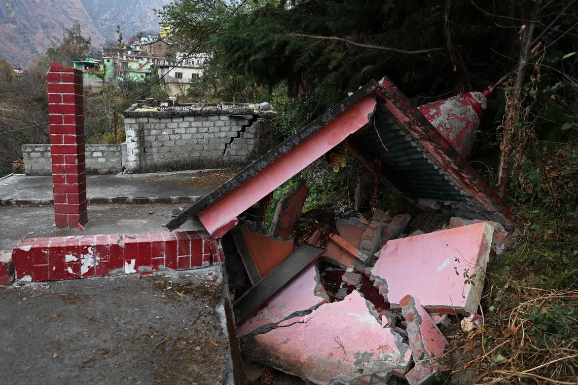 Damaged walls crumble at a temple near a house in the Singdhar area of Joshimath, in the northern state of Uttarakhand, India, Jan 13, 2023. Indian Prime Minister Narendra Modi's push to carve roads and rail deep into the Himalayan mountains is smoothing the way for millions of Hindu and Sikh pilgrims to visit a clutch of religious sites that include the source of the Ganges river. The strategy has run into trouble, however, with some works halted by local authorities in the face of protests by residents after hundreds of houses were damaged by subsidence along the routes. The buildings and the land beneath houses had been weakened - geologists, residents and officials say - by rapid construction in the geologically unstable mountains.    