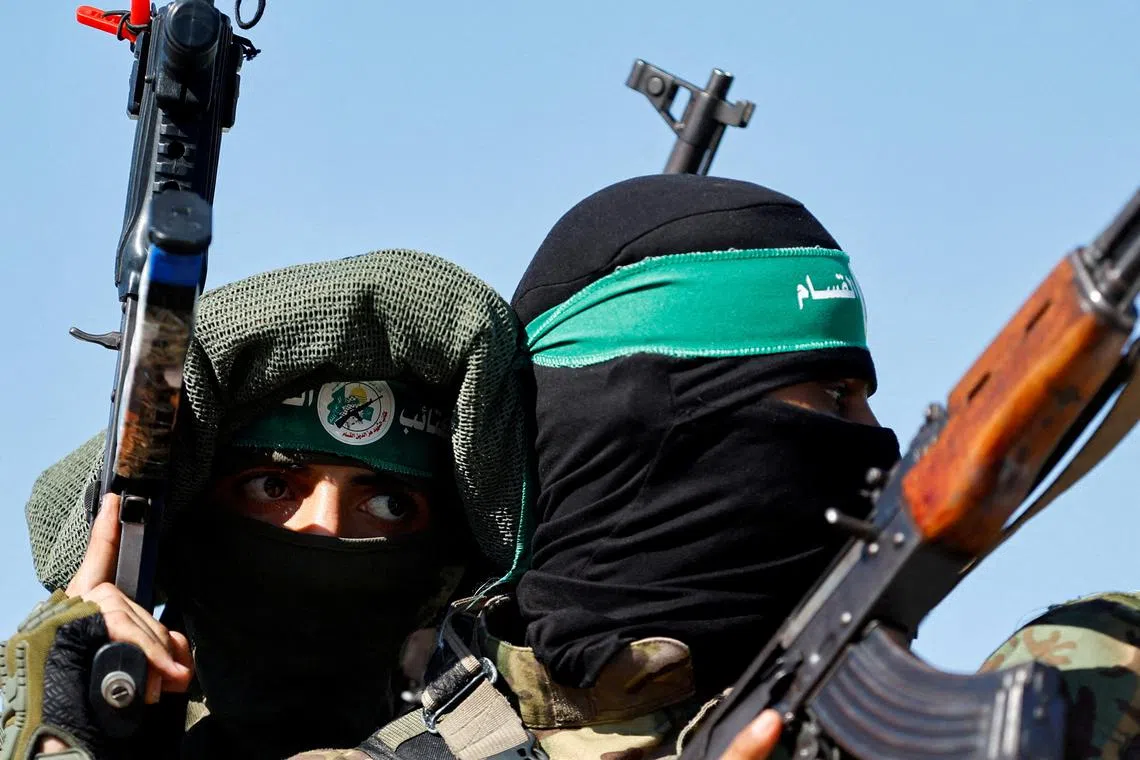 FILE PHOTO: Palestinian fighters from the armed wing of Hamas take part in a military parade to mark the anniversary of the 2014 war with Israel, in the central Gaza Strip, July 19, 2023. REUTERS/Ibraheem Abu Mustafa/File Photo
