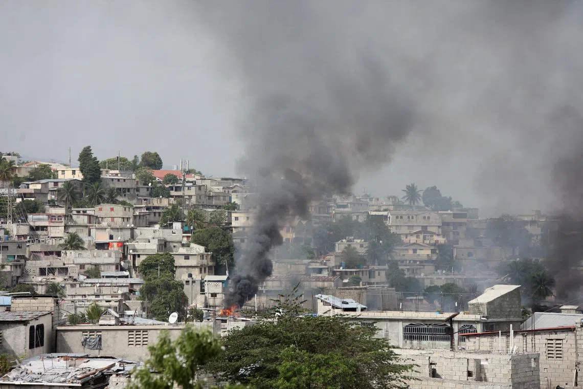 FILE PHOTO: A house set ablaze by gangs in the Delmas 30 neighborhood is pictured as police officers clash with gangs amid ongoing violence, in Port-au-Prince, Haiti, February 26, 2025. REUTERS/Fildor Pq Egeder/File Photo