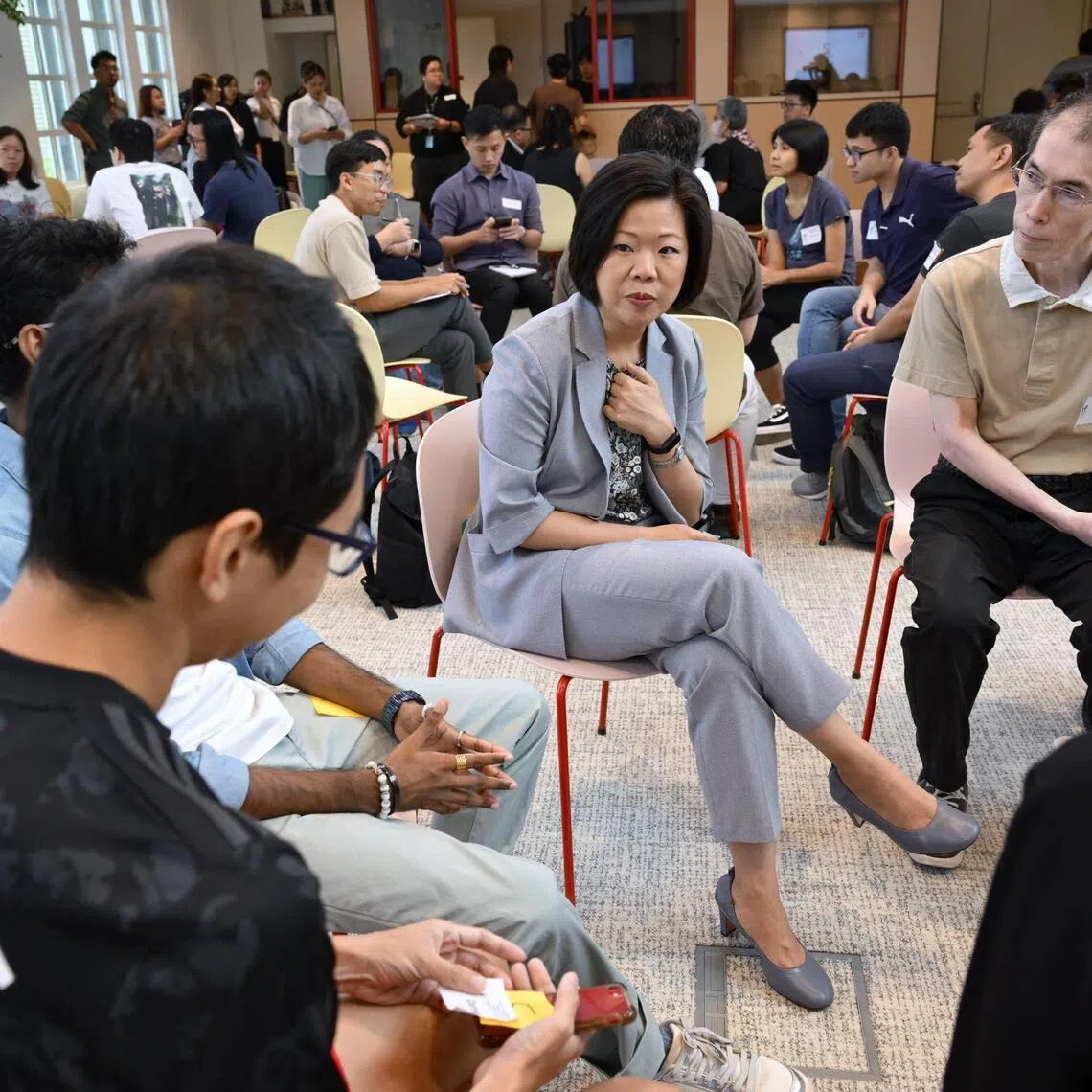 Senior Minister of State for Home Affairs Sim Ann speaking with attendess at the "Holding the Centre: Navigating Online Polarisation" forum on June 13.