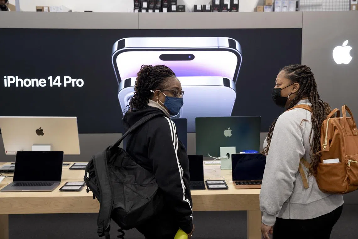 Customers look at Apple products at a Best Buy in Alexandria, Virginia, in the US, on Black Friday.