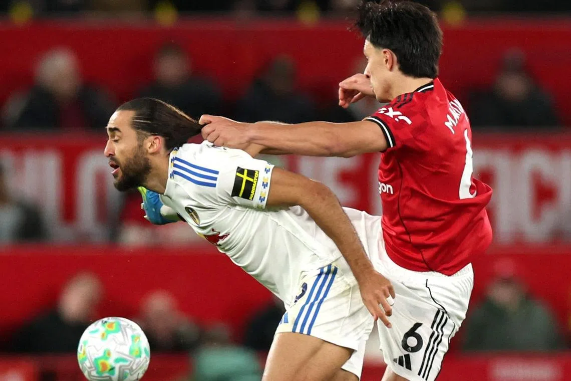 Manchester United's Lisandro Martinez fouls Leeds United's Dominic Calvert-Lewin and is later shown a red card after a VAR review.