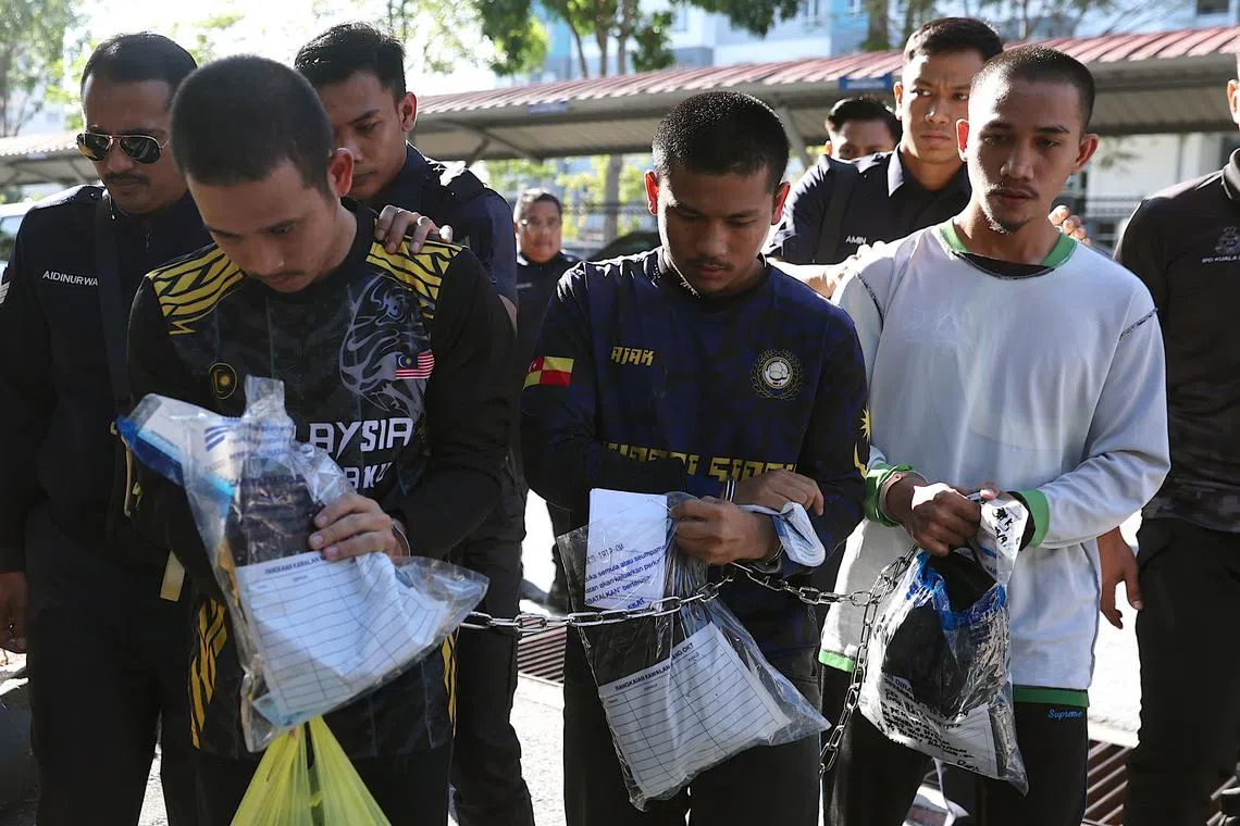 The suspects were brought to the court complex in a police van around 9.10am.