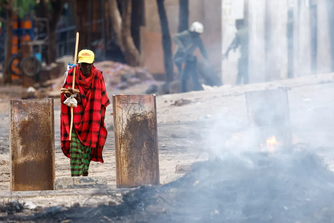 A man walks on a deserted street, following a protest a day after a general election marred by violent demonstrations over the exclusion of two leading opposition candidates at the Namanga One-Post Border crossing point between Kenya and Tanzania, October 30, 2025. REUTERS/Thomas Mukoya
