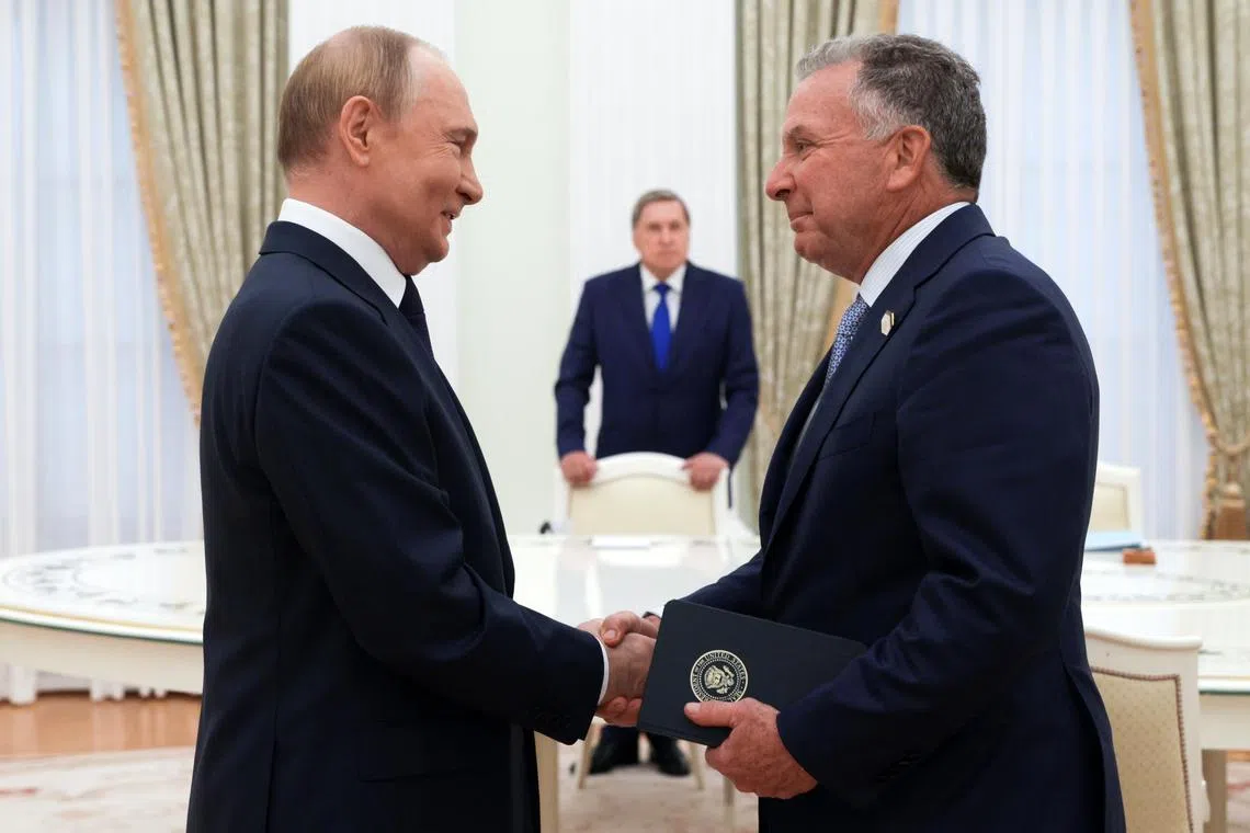 Russian President Vladimir Putin (L) and US envoy Steve Witkoff shake hands before a meeting at the Kremlin in Moscow.