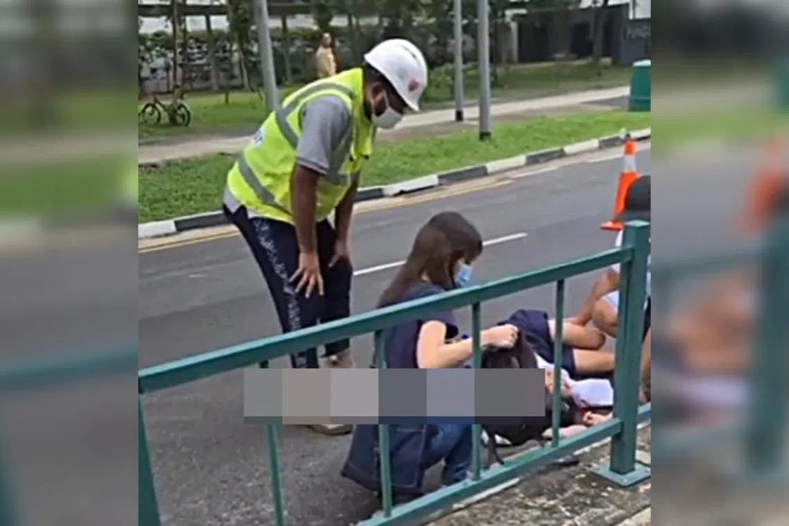 Photos uploaded online showed the boy lying on the road in his school uniform while a woman and a construction worker tended to him.