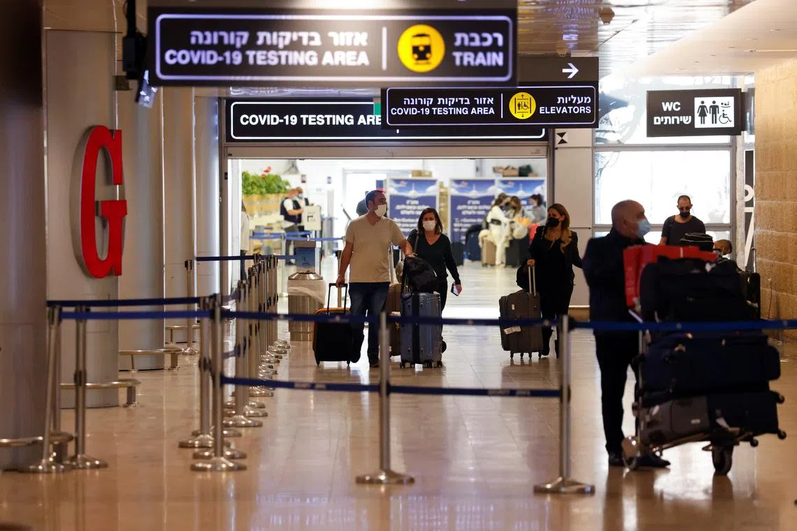 Travellers exit the coronavirus disease (COVID-19) pandemic testing area at Ben Gurion International Airport near Tel Aviv, Israel November 28, 2021. REUTERS/Amir Cohen/File Photo