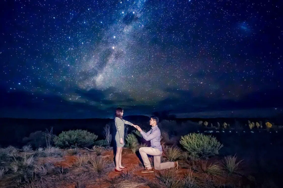 Sherman Sim proposing to his then-girlfriend Stefanie Tan in 2015 under the stars in the Australian outback, Uluru.