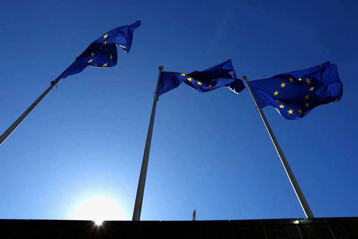 FILE PHOTO: European Union flags flutter outside the EU Commission headquarters in Brussels, Belgium March 18, 2025. REUTERS/Yves Herman/File Photo